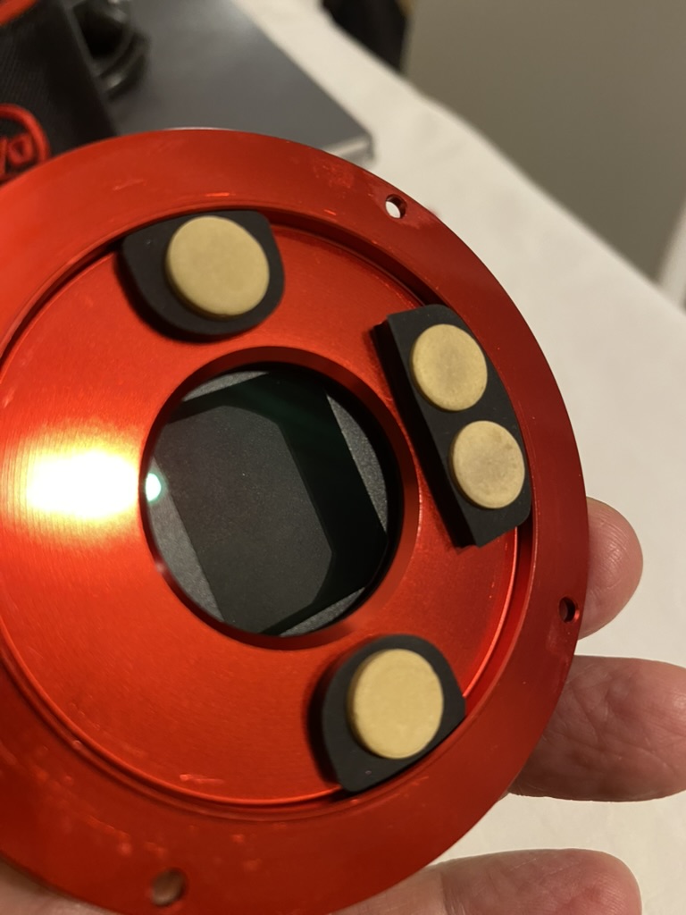 Four desiccant tablets mounted on the inside of the camera front assembly